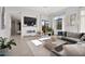 Spacious living room featuring a modern fireplace and large TV at 10929 E North Ln, Scottsdale, AZ 85259