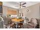 Bright dining area with wood table and chairs, plus comfy armchair at 11840 N 49Th Ave, Glendale, AZ 85304
