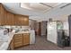 Kitchen with wood cabinets, ample counter space, and a view to dining area at 11840 N 49Th Ave, Glendale, AZ 85304