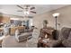 Spacious living room with a view into the kitchen and a ceiling fan at 11840 N 49Th Ave, Glendale, AZ 85304