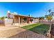 Backyard with covered patio, grassy area, and storage shed at 1243 E Avenida Grande --, Casa Grande, AZ 85122