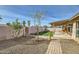 Backyard with covered patio, grassy area, and brick walkway at 1243 E Avenida Grande --, Casa Grande, AZ 85122