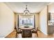 Bright dining area with a large window and wood table at 1243 E Avenida Grande --, Casa Grande, AZ 85122