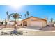 Tan house with a two-car garage and palm trees at 1243 E Avenida Grande --, Casa Grande, AZ 85122