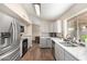 Updated kitchen with modern gray cabinets and stainless steel appliances at 1243 E Avenida Grande --, Casa Grande, AZ 85122
