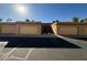 Front view of a tan colored complex, featuring multiple garages and a walkway at 1319 E Susan Ln, Tempe, AZ 85288