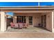 Covered patio with seating area, brick pavers, and access to the backyard at 13631 W Banff Ln, Surprise, AZ 85379