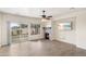 Bright living room featuring a sliding glass door, backyard access, and a stone fireplace at 1427 E Saddlebrook Ct, Casa Grande, AZ 85122