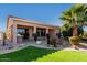 Landscaped backyard with patio and green grass at 17770 W Cottonwood Ln, Goodyear, AZ 85338