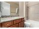 Bathroom boasts granite countertop, wood cabinets and bathtub at 17770 W Cottonwood Ln, Goodyear, AZ 85338