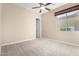 Bright bedroom featuring ceiling fan and neutral carpeting at 17770 W Cottonwood Ln, Goodyear, AZ 85338