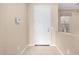 Light beige entryway with white door, security system, and tile flooring at 17770 W Cottonwood Ln, Goodyear, AZ 85338