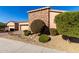 House exterior with stone accents, lush landscaping, and a two-car garage at 17770 W Cottonwood Ln, Goodyear, AZ 85338