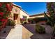 Landscaped front yard with walkway leading to the front door and red flowers at 17770 W Cottonwood Ln, Goodyear, AZ 85338