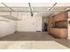 Garage interior with storage cabinets, overhead rack, and epoxy flooring at 17770 W Cottonwood Ln, Goodyear, AZ 85338