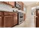 Bright kitchen with double oven, granite countertops, and tiled floors at 17770 W Cottonwood Ln, Goodyear, AZ 85338
