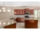 Granite countertops and dark wood cabinets in kitchen at 17770 W Cottonwood Ln, Goodyear, AZ 85338