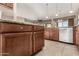 Island kitchen with granite countertops and stainless steel dishwasher at 17770 W Cottonwood Ln, Goodyear, AZ 85338