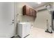 Laundry room with cabinets, sink, and built-in shelving at 17770 W Cottonwood Ln, Goodyear, AZ 85338