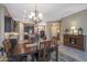 Elegant dining room with chandelier and hardwood floors, adjacent to kitchen at 2026 N Atwood --, Mesa, AZ 85207