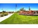 Community entrance with landscaping and flags at 2026 N Atwood --, Mesa, AZ 85207