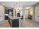 Open concept kitchen boasts a large island, dark cabinetry, and access to entryway at 2026 N Atwood --, Mesa, AZ 85207