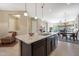 Spacious kitchen with granite island, dark cabinetry, and stainless steel appliances at 2026 N Atwood --, Mesa, AZ 85207