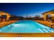 Community pool with lights and seating areas at night at 2026 N Atwood --, Mesa, AZ 85207