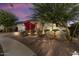 One story home with red flowers and gray garage at dusk at 20584 W Pasadena Ave, Litchfield Park, AZ 85340