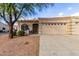 Tan stucco house with two-car garage and landscaped front yard at 2101 S Yellow Wood -- # 75, Mesa, AZ 85209