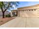 Tan stucco house with two-car garage and landscaped front yard at 2101 S Yellow Wood -- # 75, Mesa, AZ 85209