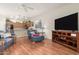 Living room with hardwood floors, open kitchen, and sectional sofa at 2101 S Yellow Wood -- # 75, Mesa, AZ 85209