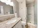 Updated bathroom with granite vanity, shower, and white fixtures at 2228 E Campbell Ave # 121, Phoenix, AZ 85016