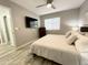 King-size bed in a well-lit bedroom with wood floors at 2228 E Campbell Ave # 121, Phoenix, AZ 85016