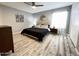 King bedroom with updated flooring and a large mirror at 2228 E Campbell Ave # 121, Phoenix, AZ 85016