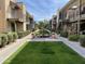 Community courtyard with lush landscaping and a central fountain at 2228 E Campbell Ave # 121, Phoenix, AZ 85016