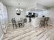 Kitchen and dining area with glass table, four chairs, and modern chandelier at 2228 E Campbell Ave # 121, Phoenix, AZ 85016
