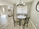 Elegant dining area with glass table and chandelier at 2228 E Campbell Ave # 121, Phoenix, AZ 85016