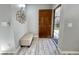 Inviting entryway with wood-look floors and bench at 2228 E Campbell Ave # 121, Phoenix, AZ 85016