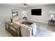Living room boasts a large TV, comfortable seating, and wood-look floors at 2228 E Campbell Ave # 121, Phoenix, AZ 85016