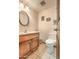 Powder room with wood vanity and tiled floor at 2930 W Belmont Ave, Phoenix, AZ 85051