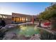 Stunning pool with a waterfall feature, spacious patio, and outdoor kitchen at 29991 N 78Th Pl, Scottsdale, AZ 85266