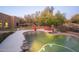Inviting backyard oasis featuring a sparkling pool, lush landscaping, and relaxing patio area at 29991 N 78Th Pl, Scottsdale, AZ 85266