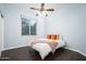 Bedroom with a full bed, ceiling fan, and large window at 29991 N 78Th Pl, Scottsdale, AZ 85266