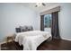 Bright bedroom with a queen bed, neutral decor, and dark wood floors at 29991 N 78Th Pl, Scottsdale, AZ 85266