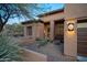 Front entry of home with desert landscaping and a security door at 29991 N 78Th Pl, Scottsdale, AZ 85266