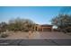 This tan home has a two-car garage and desert landscaping at 29991 N 78Th Pl, Scottsdale, AZ 85266