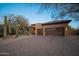 Tan two-car garage and paver driveway are featured in this home exterior at 29991 N 78Th Pl, Scottsdale, AZ 85266