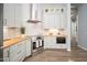 Modern kitchen with white cabinets, stainless steel appliances, and wood countertops at 29991 N 78Th Pl, Scottsdale, AZ 85266