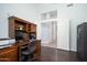 Bright home office with wood desk and built-in shelving at 29991 N 78Th Pl, Scottsdale, AZ 85266